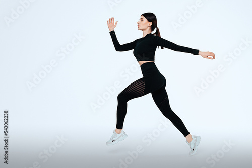 Woman runner in silhouette on isolated background. Dynamic movement. Side view