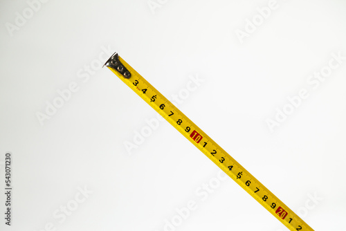 Yellow centimeter tape measure on neutral background. Measuring tape concept. Measurement concept.