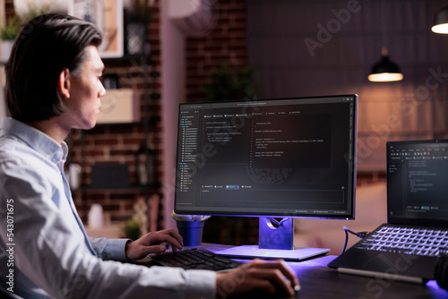 Asian coder programming server encryption on firewall software, using security network interface to code system data for app development. Working with binary code text to script program. © DC Studio
