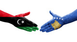 Handshake between Kosovo and Libya flags painted on hands, isolated transparent image.