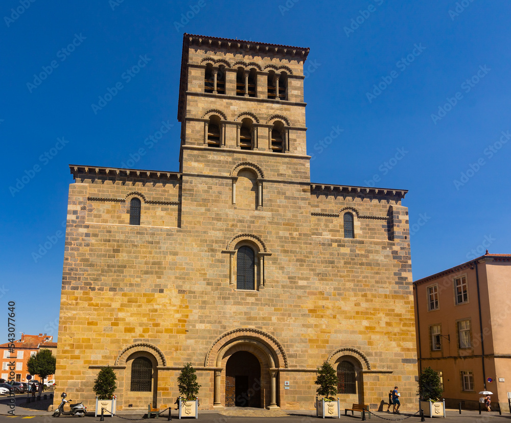 View of west facade of medieval Catholic church of Saint-Austremoine in small French town of Issoire on summer day, Auvergne