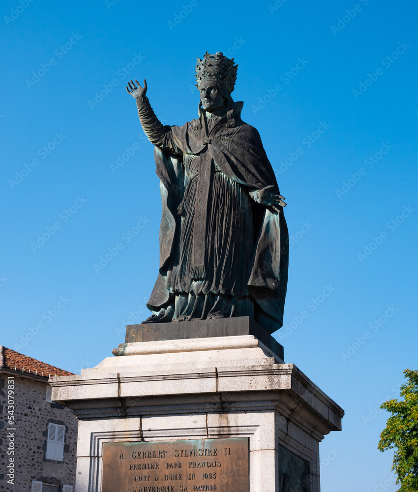 Statue of Pope Sylvester II, medieval scholar and clergyman in French city of Aurillac on sunny summer day