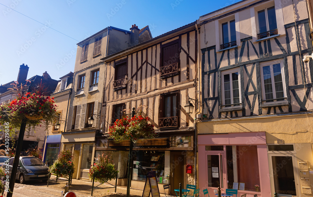 View of ancient half-timbered residential houses in old town of Provins on sunny summer day, France.