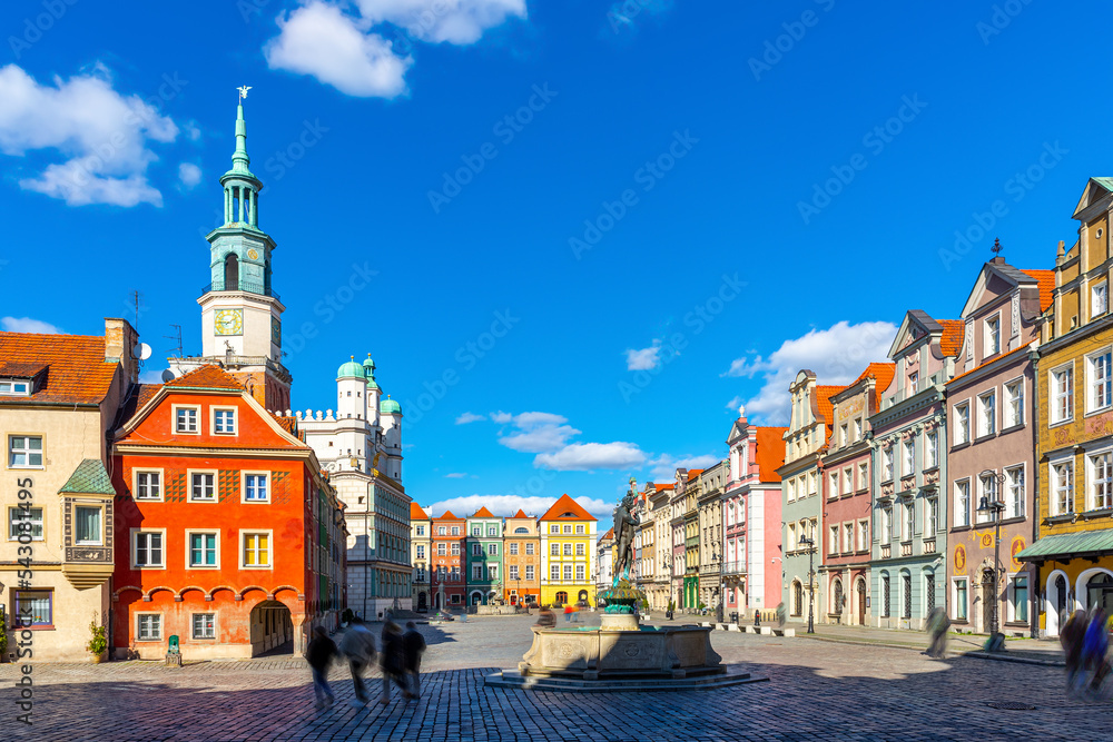 Picturesque cityscape of Poznan Market Square with historic Town Hall and Fountain of Apollo surrounded by colorful townhouses in spring day, Poland