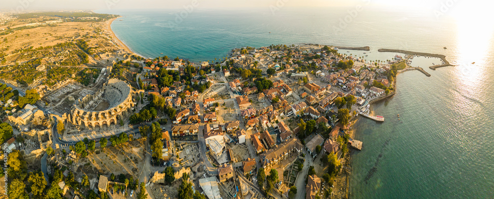 Fototapeta premium Aerial panoramic cityscape of Side, a resort town, in Antalya Province, Turkey, surrounded by the Mediterranean Sea, during the sunset,. High quality photo