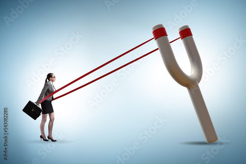 Photo Businesswoman being launched from slingshot in career concept