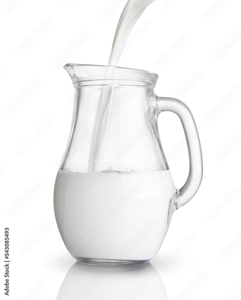 Pouring milk in a glass jug isolated Pouring milk in a glass jug isolated