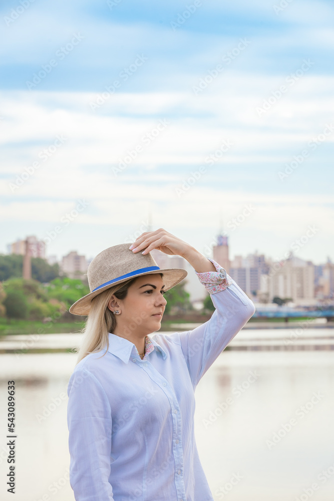 Agribusiness woman wearing hat and jeans at the end of a working day..