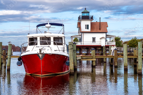 A Red Boat Docked Near the Roanoke River Lighthouse in Edenton North Carolina photo