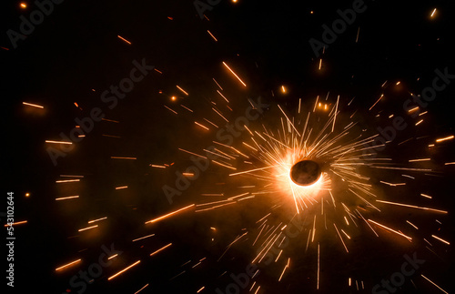 A top view of a type of firework/cracker known as Chakra or Chakri rotating on the ground, during the Diwali festival celebrations in India. photo