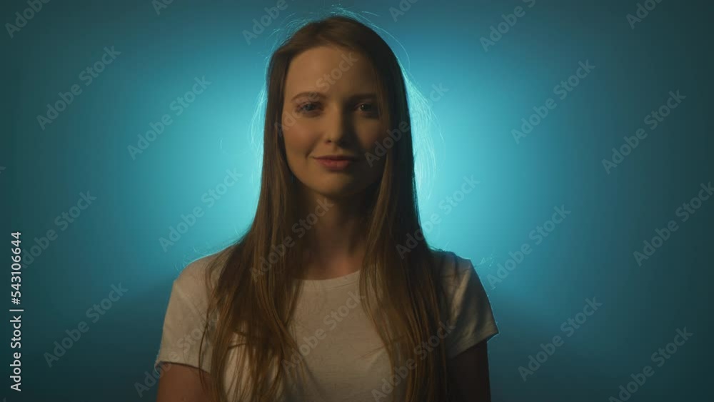 Blue light projected behind a smiling girl Blue light projected behind a smiling girl