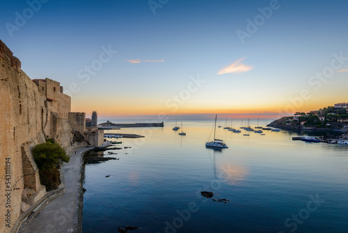 Collioure harbor and medieval castle at sunrise in France