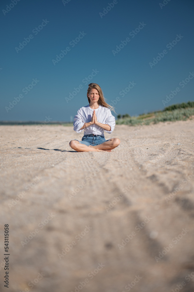 Girl practice meditation on the beach. With space for text or design