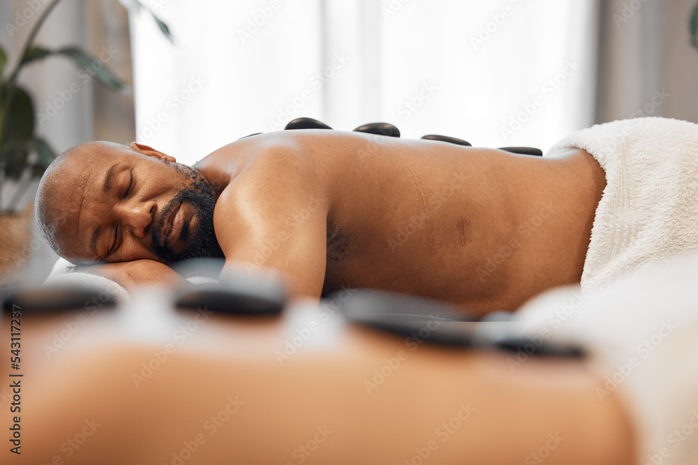 Relax, hot stone massage and mature couple together in luxury hotel spa or  salon for romantic anniversary weekend. Health, wellness and romance,  relaxing sleep for mature black man on summer vacation Stock