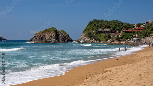 Waves breaking on the beach in Zipolite, Mexico photo