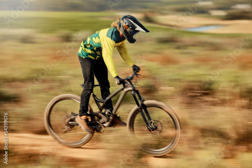 Speed, action and man on mountain bike for dirt racing sports, riding on nature trail. Sports, mountain biking and blur of athlete cycling fast on dirt road for fitness, adrenaline and adventure