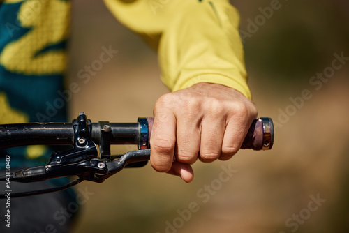 Fotografija Hand, handle and bike with a man athlete or cyclist riding outdoor for fitness, exercise or cardio