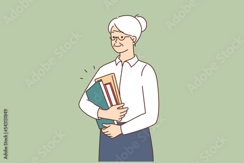 Smiling mature woman with folders at work 