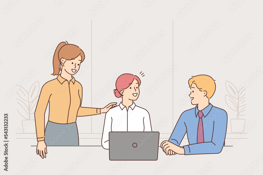 Smiling businesspeople collaborate on computer Smiling businesspeople collaborate on computer