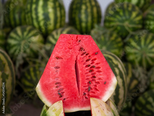 Tasty watermelon and four flies on it. photo