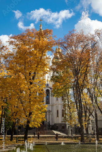 Mirror Stream fountain sight near Myrrh-bearing church. Scenic autumn sunny Kharkiv city center park with blue cloudy sky, Ukraine