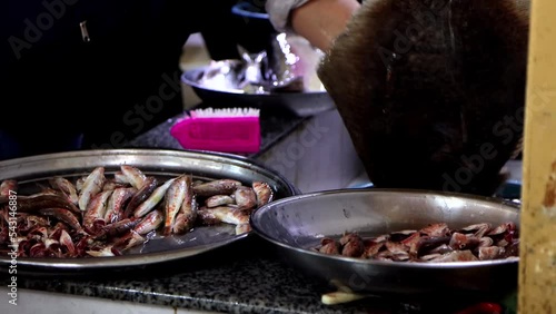 Fresh fish is preparing for sale at market. Washing and gutting fish, 4k footage. photo