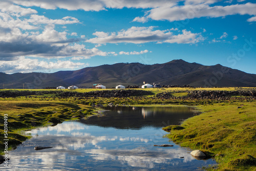 Reflection of Gers and mountains in river in Orkhon Valley in Mongolia
