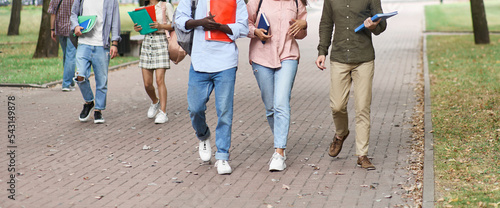 group of students walking through the park after lectures.