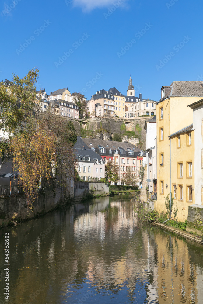 Luxembourg City Grund with Pétrusse River in the sunshine with blue sky and clouds.