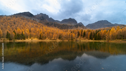 Amazing Autumn landscape on mountians lake. Dolomites Italy