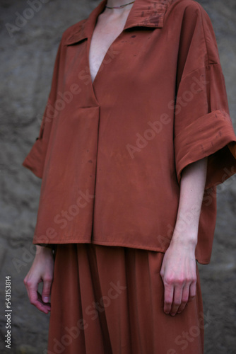 young girl in a terracotta costume in the rocks fashion