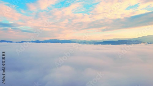Aerial view over dense fog and beautiful mountains during sunrise. landscape of tropical rainforest in winter. Phrao District, Chiang Mai Province, Northern Thailand. travel and nature concept. 4K
 photo