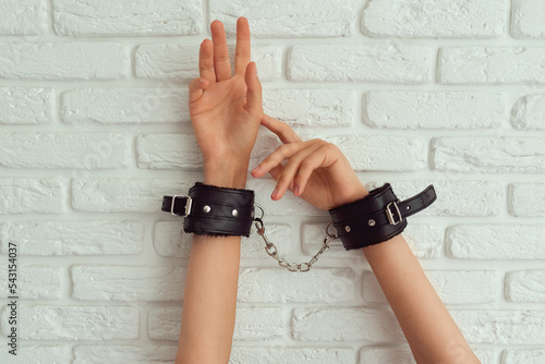 Female hand in black handcuffs for sex games