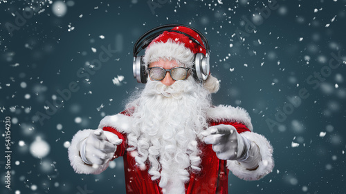 Cool Santa Claus is listening music in headphones © Igor Link