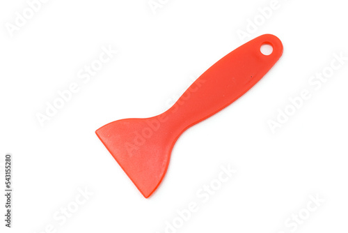 red plastic spatula raclette isolated on a white background photo