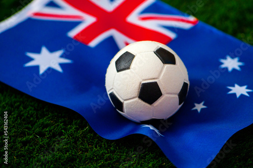 Australia national football team. National Flag on green grass and soccer ball. Football wallpaper for Championship and Tournament in 2022. World international match.