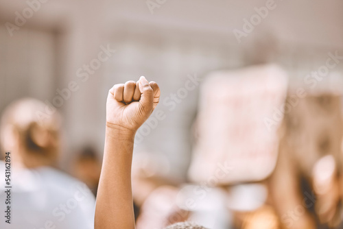 Protest, equality and fist in air in city, crowd of people in street protesting for human rights, freedom and marching. Black lives matter movement, social justice and raised hand of black person photo