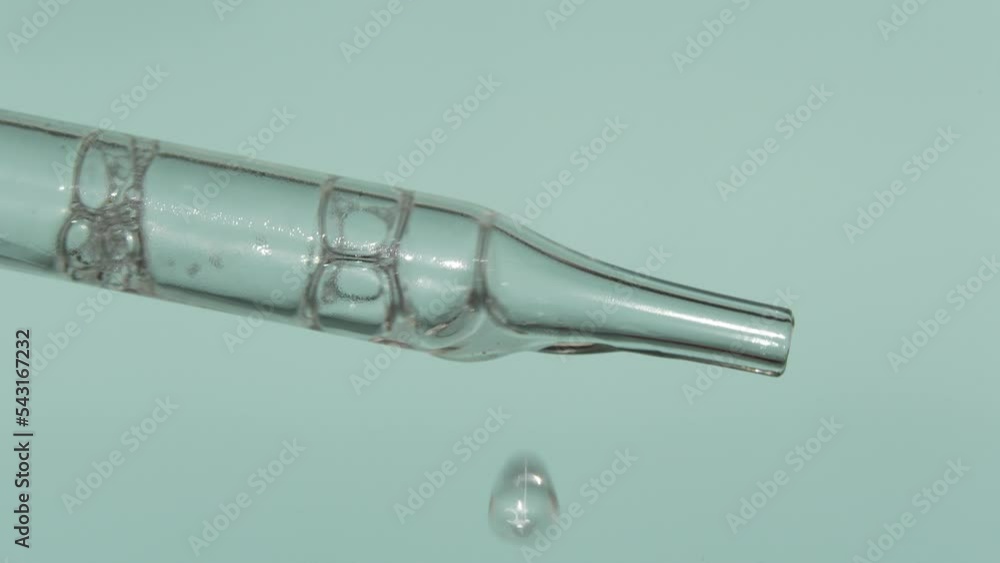 Pipette with liquid essence on a light blue background. Serum for the face. The concept of an extract for cosmetic purposes. High quality photo Pipette with liquid essence on a light blue background. Serum for the face. The concept of an extract for cosmetic purposes. High quality photo