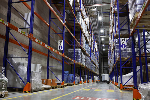 Warehouse interior with metal racks full of merchandise. Wholesale business