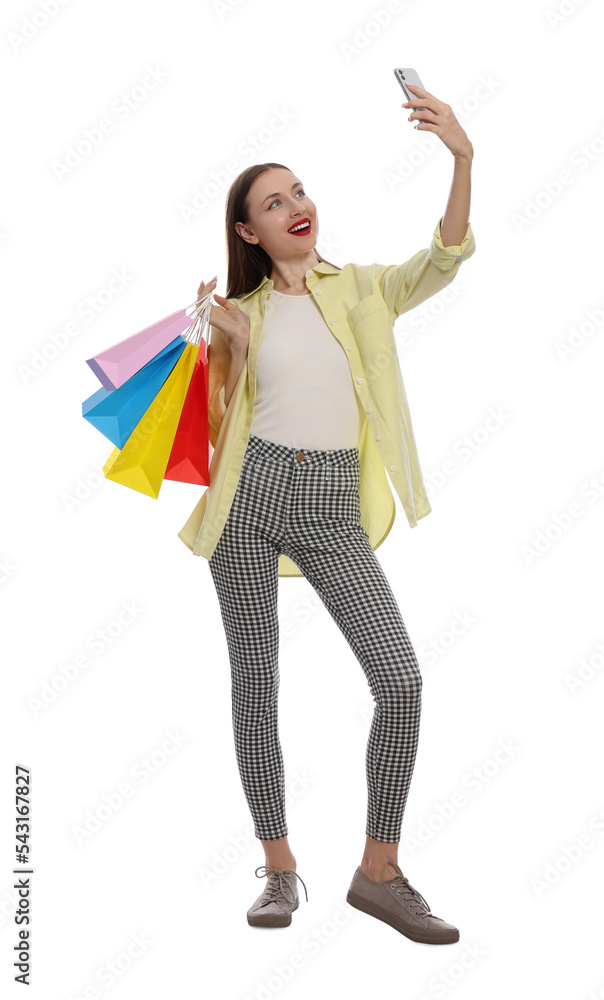 Stylish young woman with shopping bags taking selfie white background Stylish young woman with shopping bags taking selfie white background