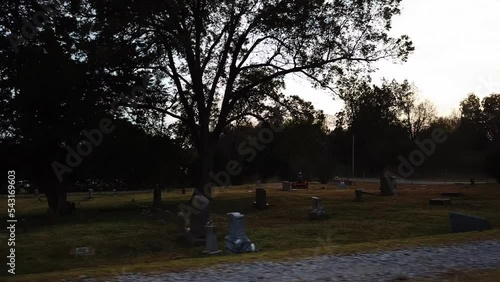 Drone shot of graveyeard at dusk. dark sunset sky.
 photo