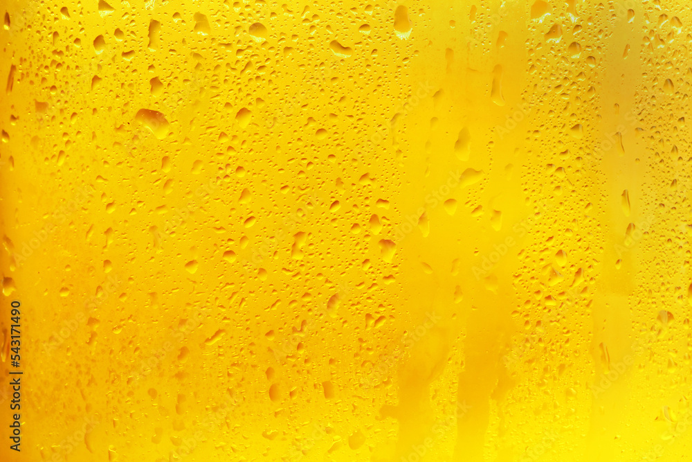 Glass of tasty cold beer with condensation drops as background, closeup Glass of tasty cold beer with condensation drops as background, closeup