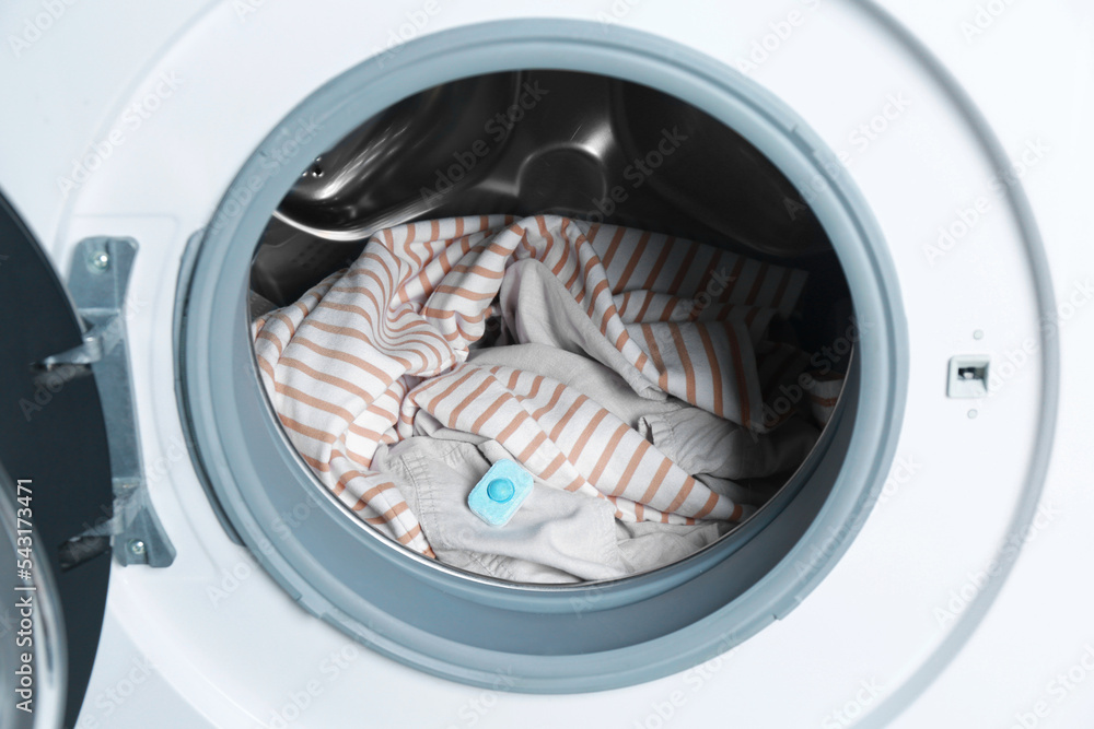 Water softener tablet on clothes in washing machine Water softener tablet on clothes in washing machine
