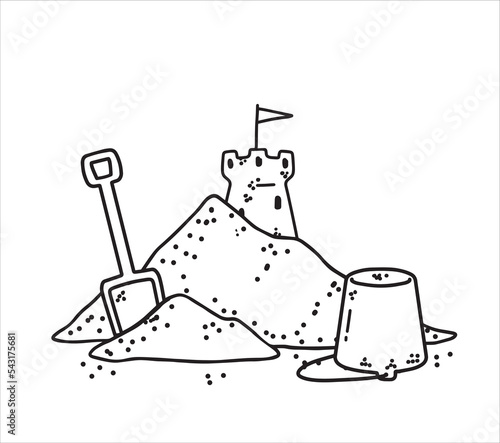 Bucket and scoop with pile of sand. Children play on beach.