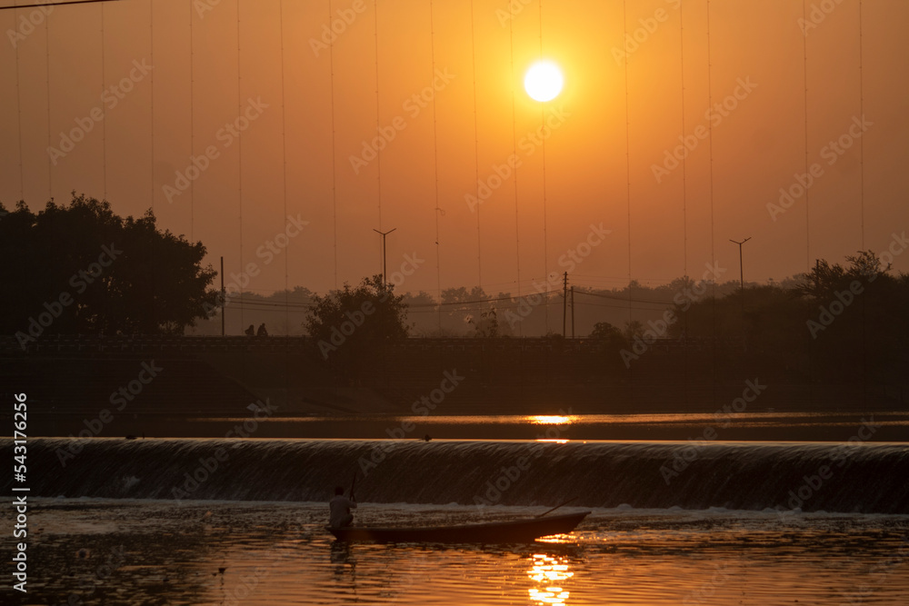 Sun Shine Over Blue Water Lake Or River At Sunrise. Nature At Sunny Morning. Woods With Orange Foliage On Riverside, Beautiful, colorful sunrise over a wide river. 