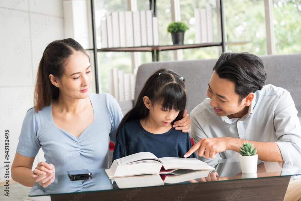 Happy family sitting together and help teaching daughter about her homework in living room. Happy family sitting together and help teaching daughter about her homework in living room.