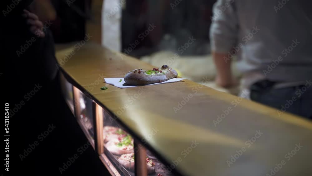 Stall Owner Sells Hot Loaves Russian Bread To Customer in Berlin Night Christmas Market Stall Owner Sells Hot Loaves Russian Bread To Customer in Berlin Night Christmas Market