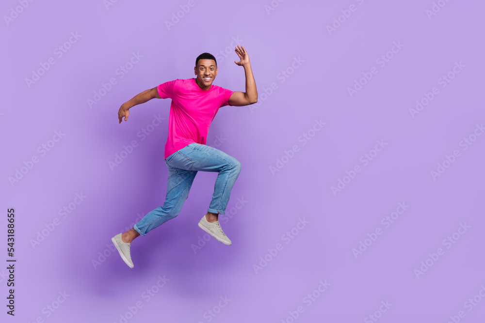 Full length photo of excited energetic person jump run rush empty space isolated on violet color background
