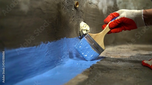 Obraz na plátne Waterproofing the floor with a brush