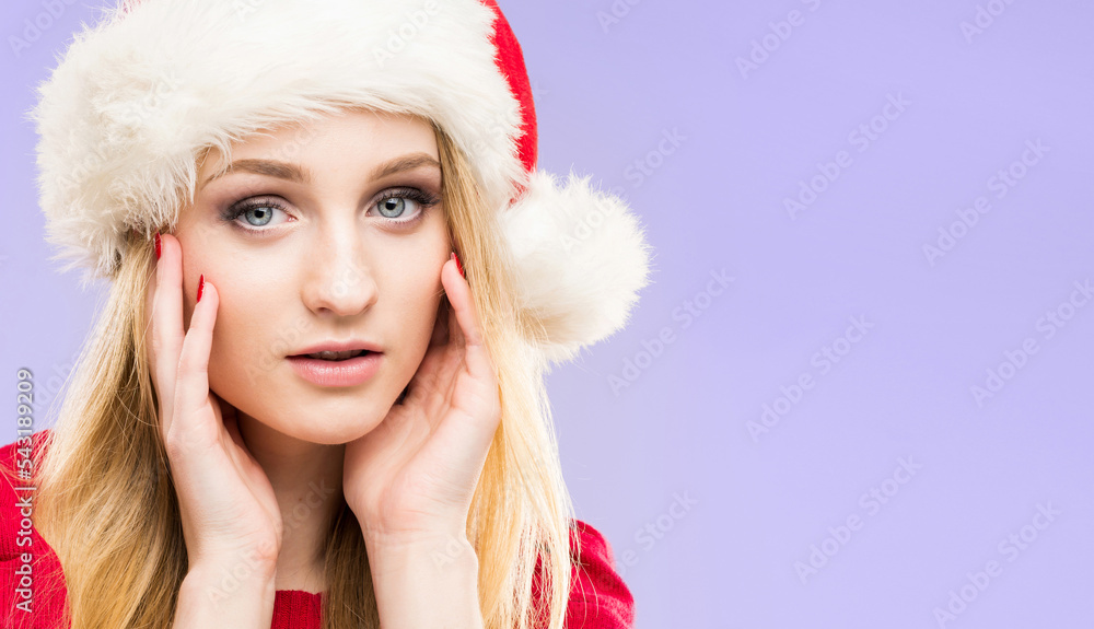 Portrait of young and pretty girl in Santa hat. New year and Christmas concept. Portrait of young and pretty girl in Santa hat. New year and Christmas concept.
